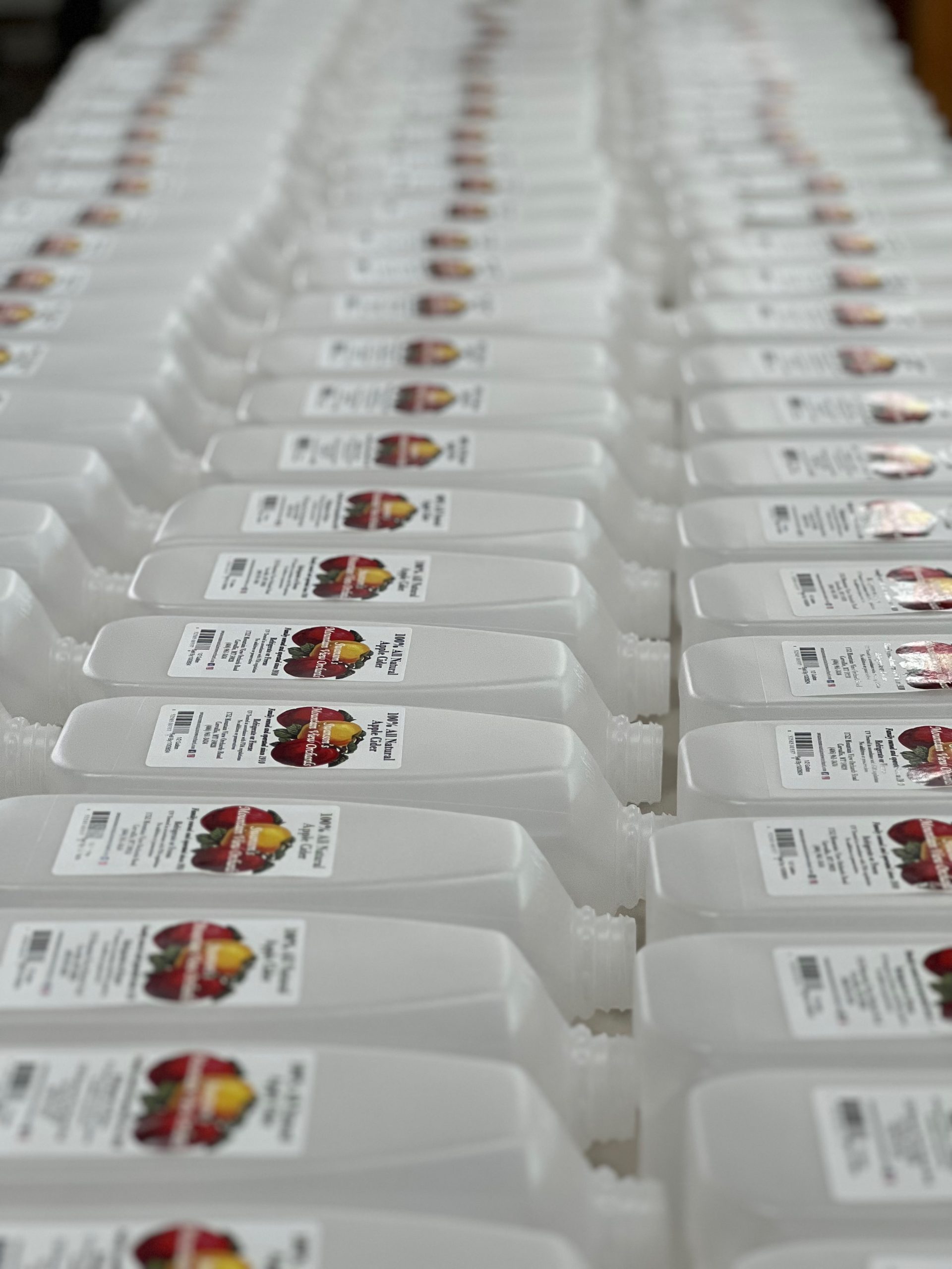 Empty apple cider gallons with Swanson's Mountain View Orchard logo