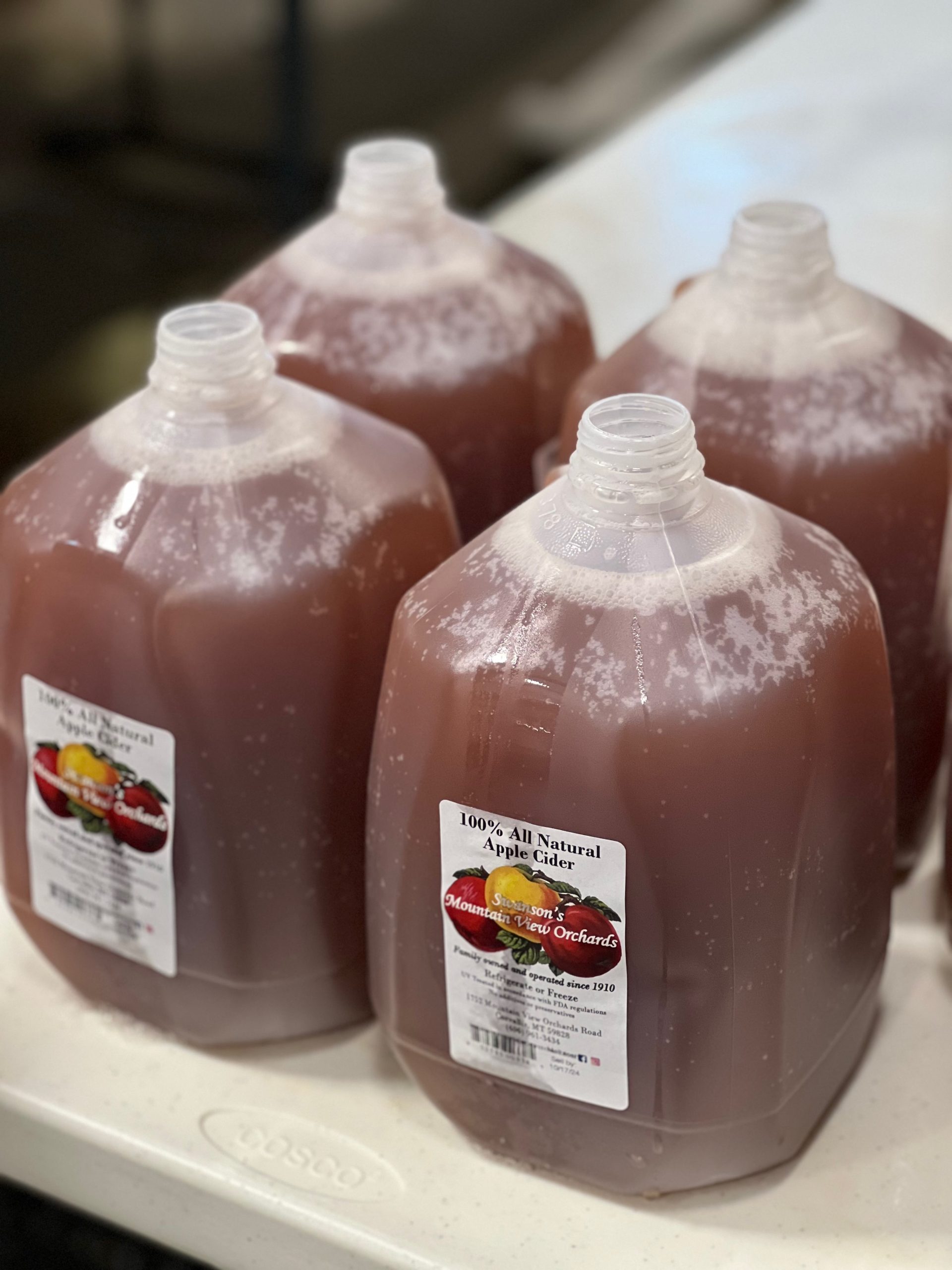 Gallons of apple cider with Swanson's Mountain View Orchard logo
